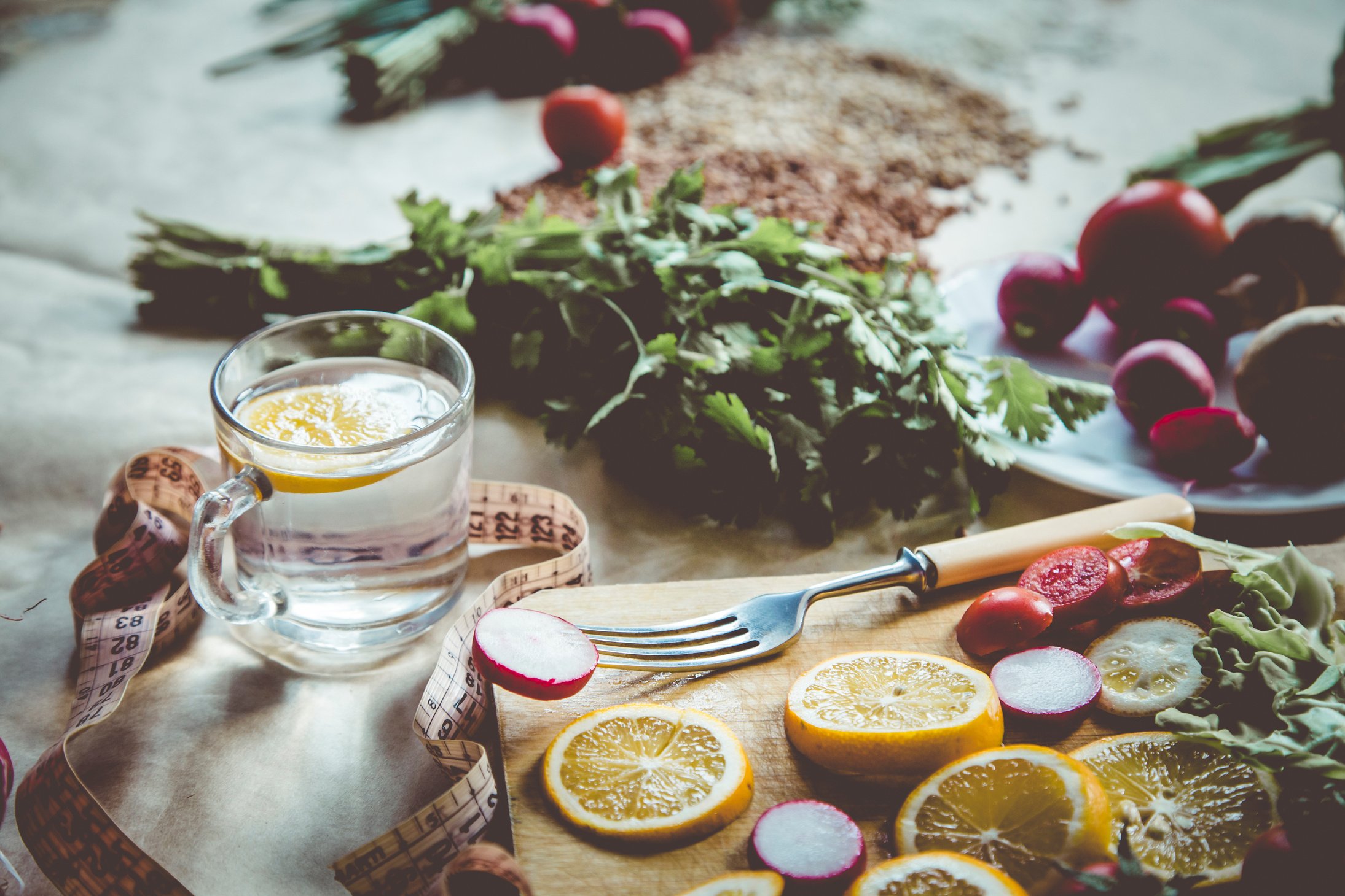 Healthy Vegan Food Background with Cutting Board and Lemon Slices. Top View to Organic Food Background with Cutting Board and Lemon Slices